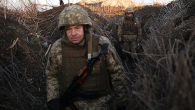 Servicemen of Ukrainian Military Forces walk along tranches on their position on the front line with Russia backed separatists.