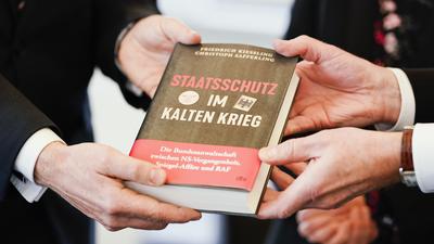 Hände halten das Buch mit dem Titel «Staatsschutz im Kalten Krieg» bei der Präsentation des Abschlussberichts zur Aufarbeitung der Geschichte der Bundesanwaltschaft. +++ dpa-Bildfunk +++