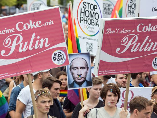 "Trink keine Coke mit Putin" steht am 31.08.2013 in Berlin auf einem Plakat als Mahnung an die Sponsoren der Olympischen Spiele 2014. Mehrere tausend Menschen zogen in einer Demonstration unter dem Motto "Enough is enough - Stop Homophobia" vom Kurfürstendamm zur russischen Botschaft und protestierten damit gegen das in Russland erlassene Homosexuellen-Gesetz. Foto: Florian Schuh/dpa ++ +++ dpa-Bildfunk +++