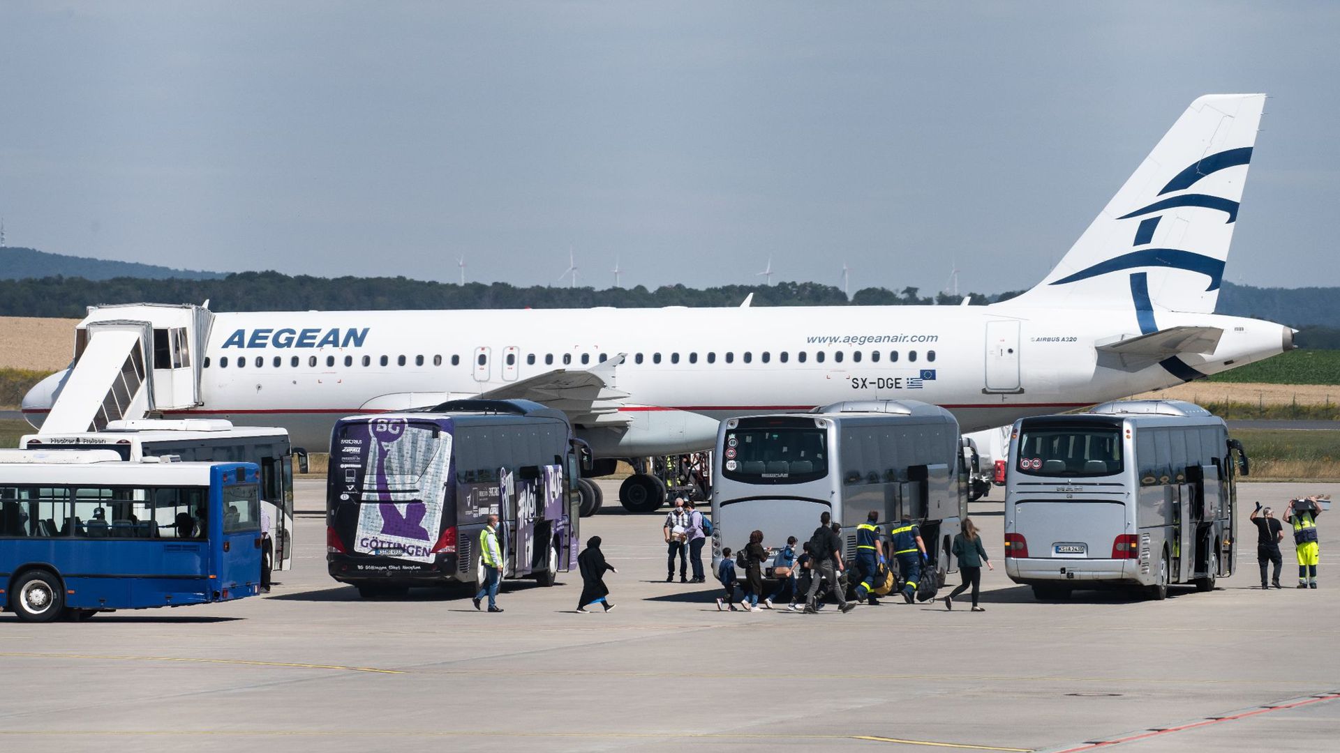 Flüchtlinge aus griechischen Flüchtlingslagern steigen aus dem Flugzeug am Flughafen Kassel-Calden.