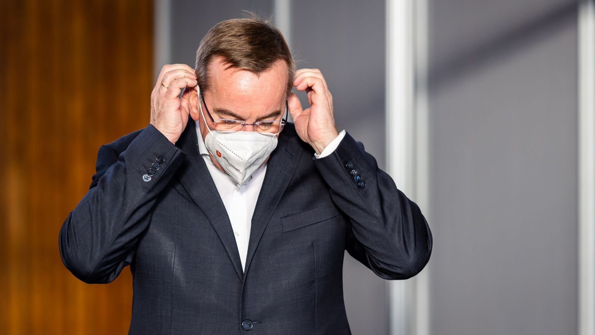 Boris Pistorius (SPD), Innenminister von Niedersachsen, setzt seine Maske auf.