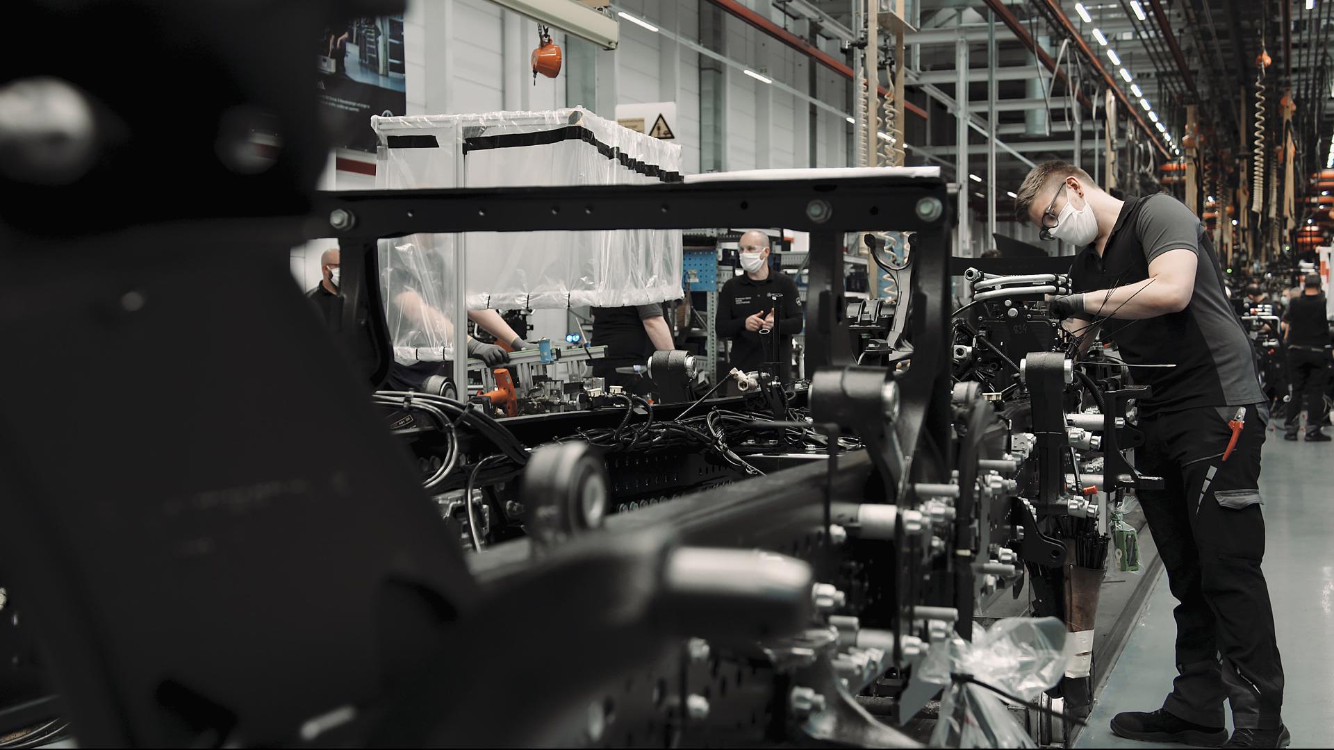 Mit Mundschutz am Montage-Band: Im Mercedes-Benz-Werk Wörth läuft die Produktion unter erschwerten Bedingungen. 