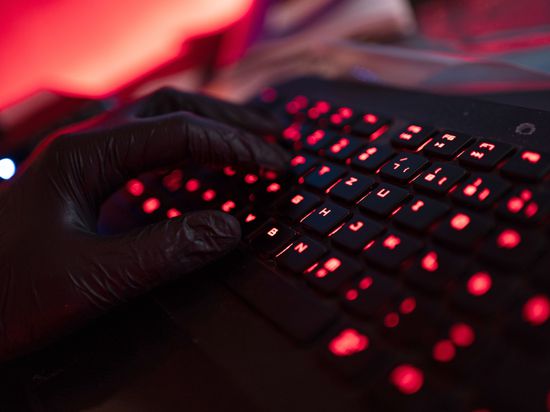 ILLUSTRATION - Ein Mann trägt Handschuhe und tippt auf einer Tastatur. Mehrere Bundestags- und Landtagsabgeordnete sind in den vergangenen Tagen das Ziel von Cyberangriffen geworden - vermutlich aus Russland. +++ dpa-Bildfunk +++