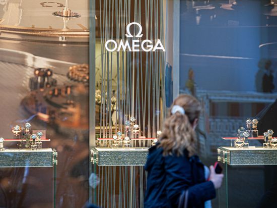 Eine Frau passiert eine Boutique des Schweizer Uhrenhersteller Omega.