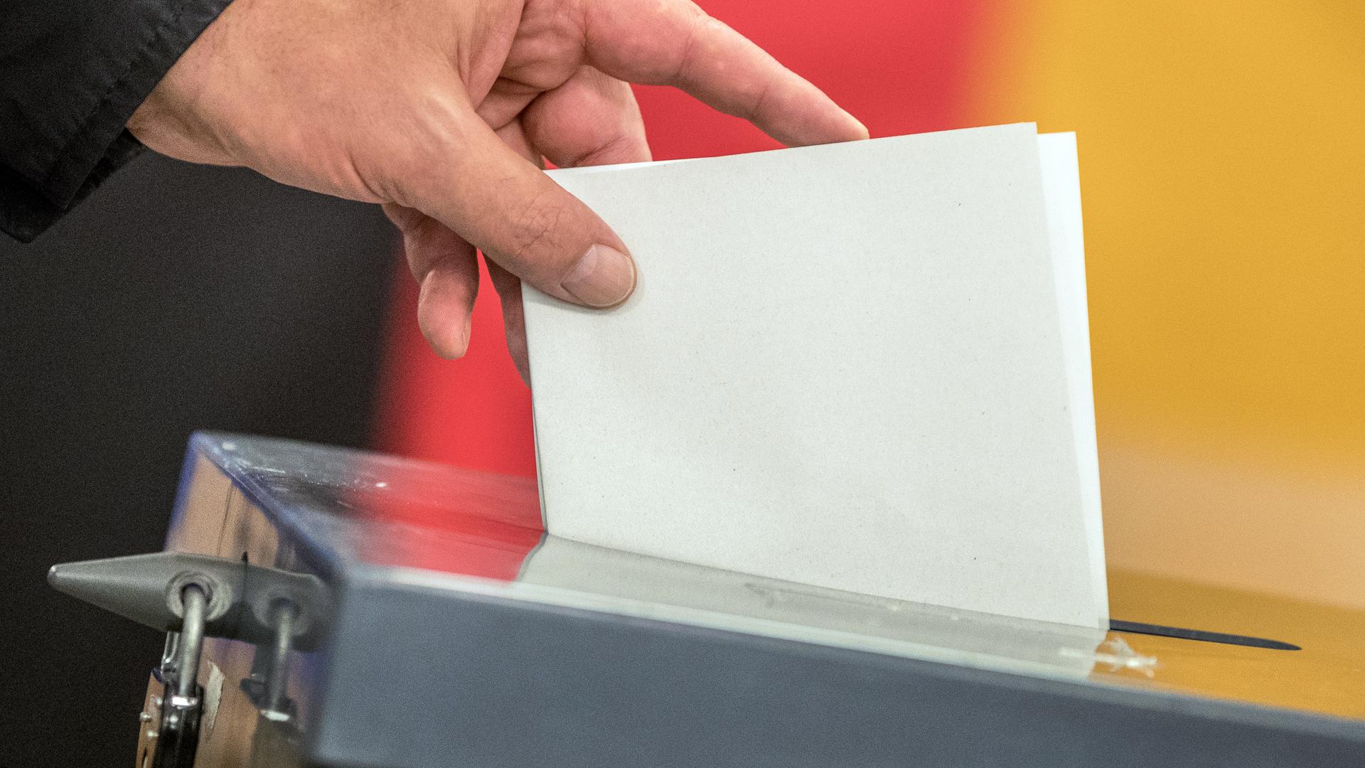 Ein Wähler wirft seinen Stimmzettel zur Wahl in die Wahlurne.