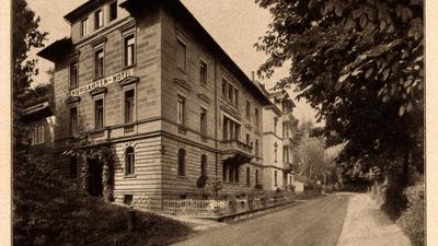 Foto früheres Kurgarten-Hotel:
Dieses Postkartenfoto aus dem Jahr 1935 zeigt das frühere Kurgarten-Hotel in Bad Wildbad, das jetzt einstürzte. Auf der anderen Straßenseite gegenüber befinden sich die Trinkhalle und der Kurpark.    