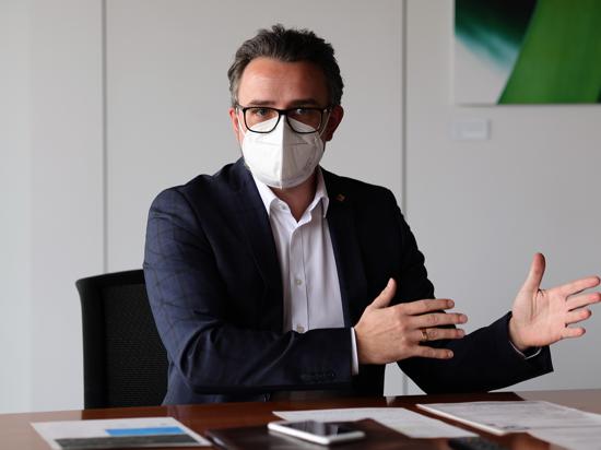 Mit Maske gestikulierend: Pforzheims Oberbürgermeister Peter Boch (CDU) gestikuliert an einem Tisch.