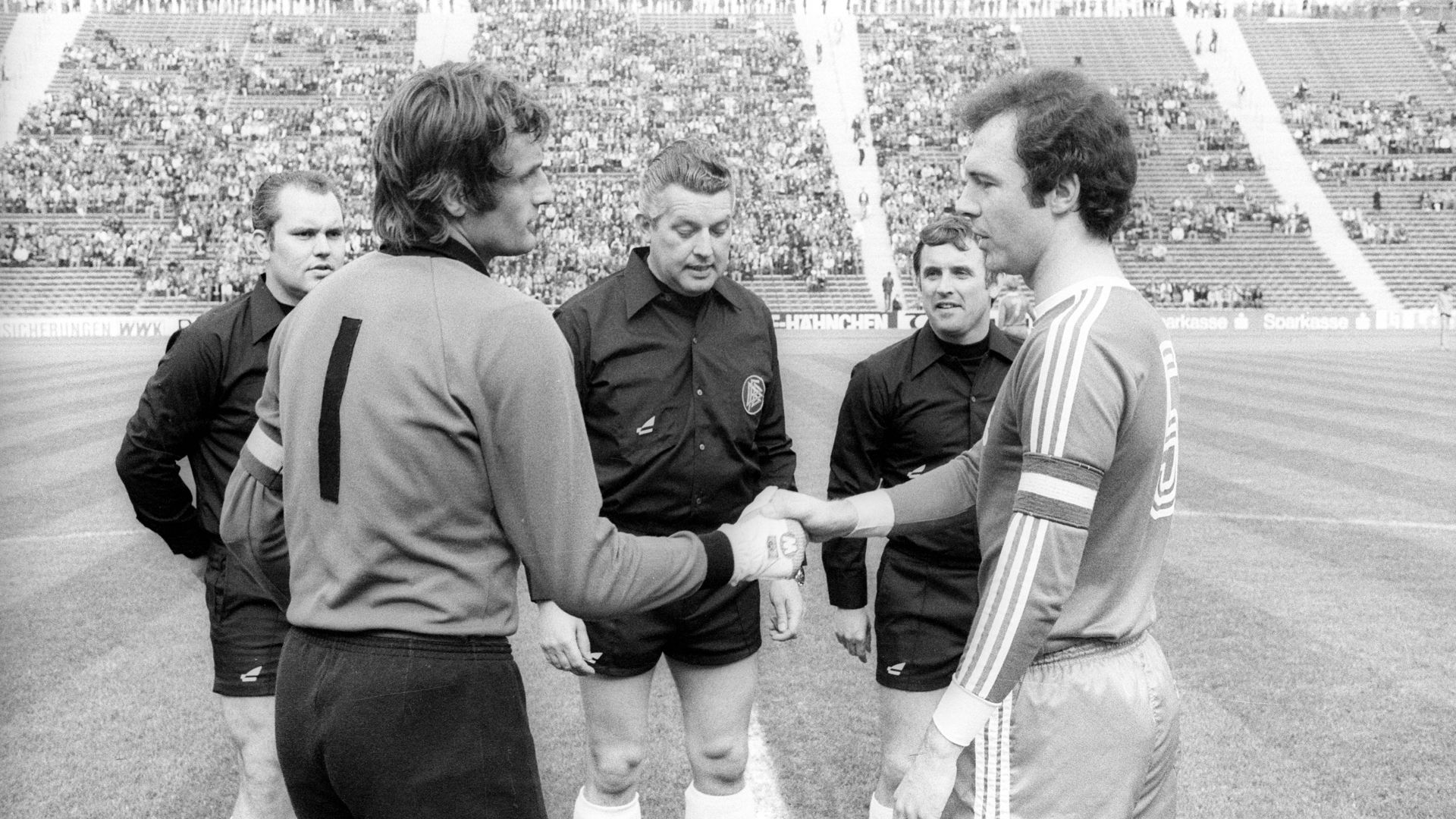 Alte Bekannte zu Beginn der 1980er: Die Kapitäne Rudolf Wimmer (links) und Franz Beckenbauer begrüßen sich vor einem Bundesligaspiel des KSC in München. 